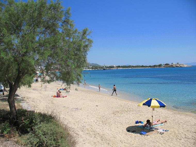 Golden sand and turquoise shallows at a west coast beach in Naxos